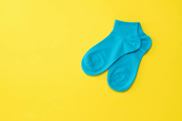 istock Blue sports socks on a bright yellow background. Flat lay. 1213799703