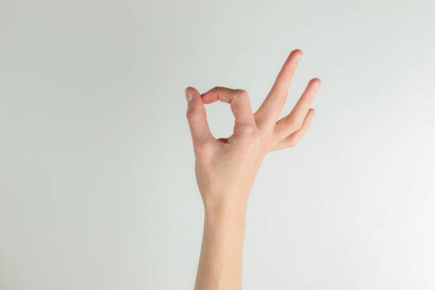 istock Female hand shows okay gesture on a white background 1213800699
