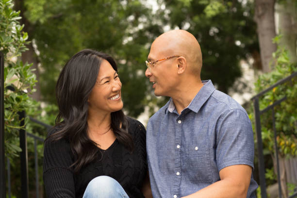 istock Happy Asian couple smiling and hugging outside. 1213801839