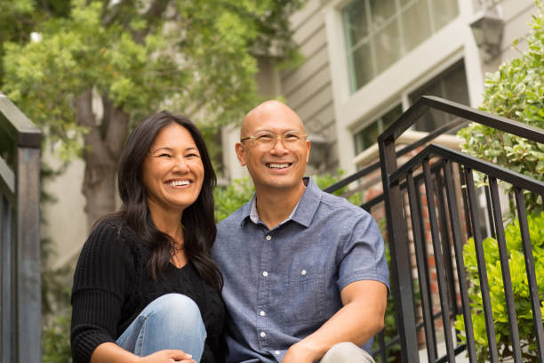 istock Happy Asian couple smiling and hugging outside. 1213801978