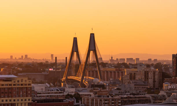 Close up aerial view of ANZAC bridge in Sydney, during sunset time with buildings in background.  The anzac bridge is an 8-lane cable-stayed bridge spanning Johnstons Bay between Pyrmont and Glebe Island close to the central business district of Sydney,Au stock photo