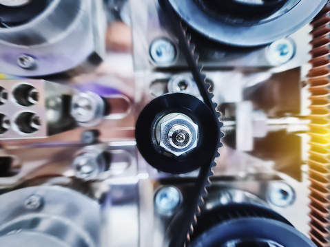 Full Frame Blurred Background of Timing Belt and Idler in Automated Machine