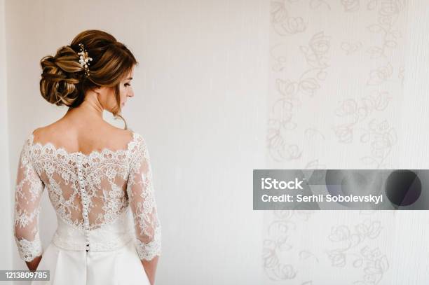 Portrait Of A Beautiful Stylish Bride With An Elegant Hairstyle View From The Back Wedding People Fashion And Beauty Concept Bride In Wedding Dress Back View Stock Photo - Download Image Now