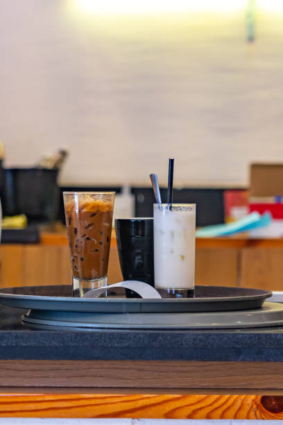 Drinks and coffee on the tray at pickup counter at coffee shop