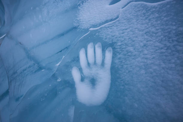 istock Human Hand Imprint on the Ice Wall in the Natural Cave 1213814577