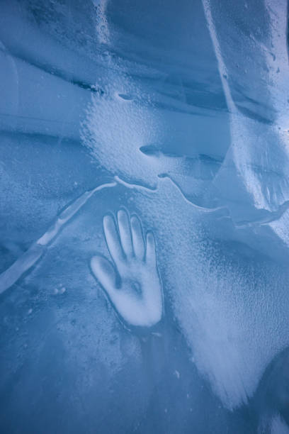 istock Human Hand Imprint on the Ice Wall in the Natural Cave 1213814644