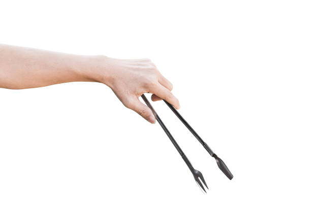 hand holding a silver fork on an isolated white background