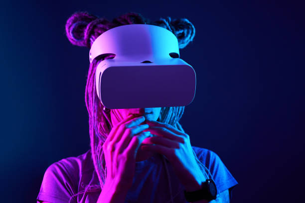 istock Woman is using virtual reality headset. Neon light studio portrait. 1213825386