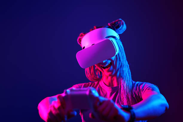istock Woman is using virtual reality headset. Neon light studio portrait. 1213825648