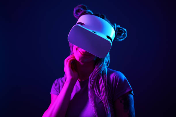 istock Woman is using virtual reality headset. Neon light studio portrait. 1213825761
