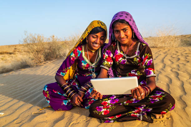 istock Happy Gypsy Indian girls using digital tablet, India 1213831302
