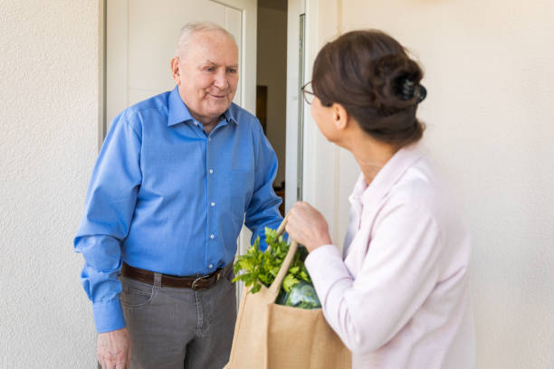 istock Quarantine – woman helping senior man 1213834190