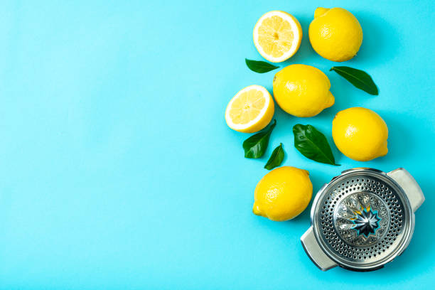 istock Ripe lemons flat lay with leaves on blue background 1213834520