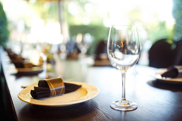 istock Wedding table served with cutlery, serviette, crockery and covered with a white tablecloth in restaurant. 1213836666