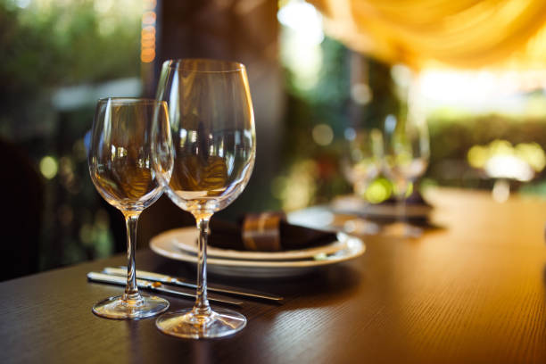 istock Wedding table served with cutlery, serviette, crockery and covered with a white tablecloth in restaurant. 1213836692