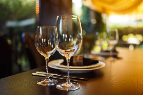 istock Wedding table served with cutlery, serviette, crockery and covered with a white tablecloth in restaurant. 1213836711