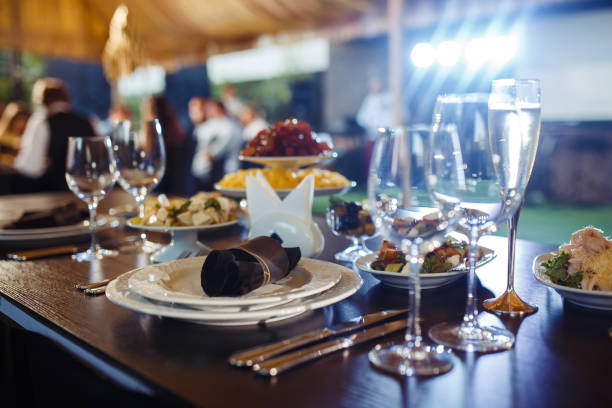 istock Wedding table served with cutlery, serviette, crockery and covered with a white tablecloth in restaurant. 1213836741