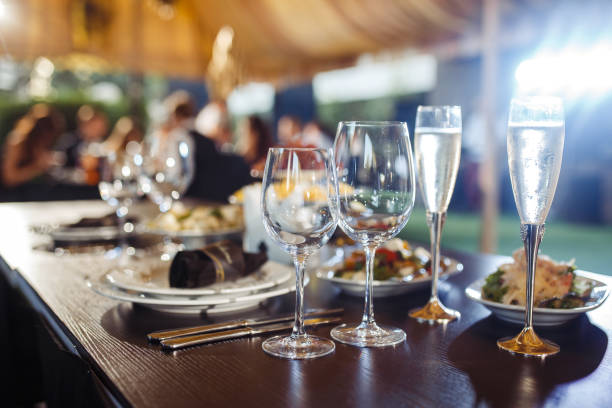 istock Wedding table served with cutlery, serviette, crockery and covered with a white tablecloth in restaurant. 1213836749
