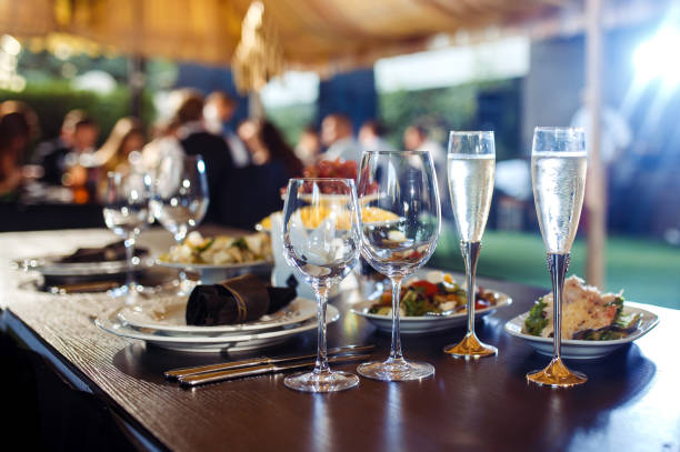 istock Wedding table served with cutlery, serviette, crockery and covered with a white tablecloth in restaurant. 1213836751
