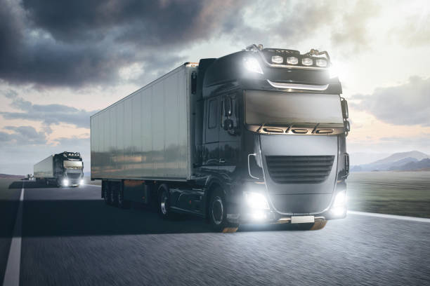 istock Trucks with trailers driving on a highway 1213837367