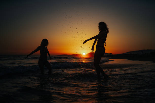 istock Carefree women having fun on beach 1213837798