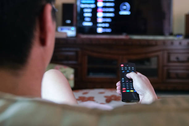 Man Using Remote Control To Watch Tv Stock Photo - Download Image Now -  Television Set, Home Interior, Men - iStock