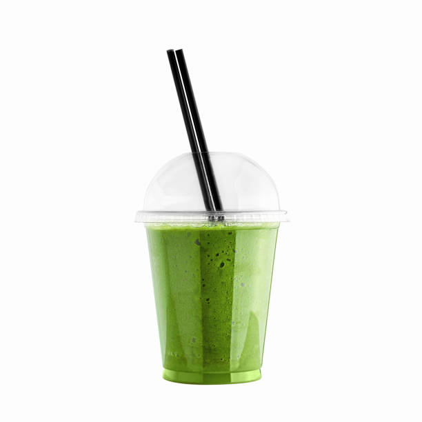 Green kiwi smoothie in plastic cup with straw isolated on white background. Kiwi or green vegetable healthy beverage. Detox drink. Green kiwi smoothie in plastic cup with straw isolated on white background. Kiwi or green vegetable healthy beverage. Detox drink. matcha tea photos stock pictures, royalty-free photos & images