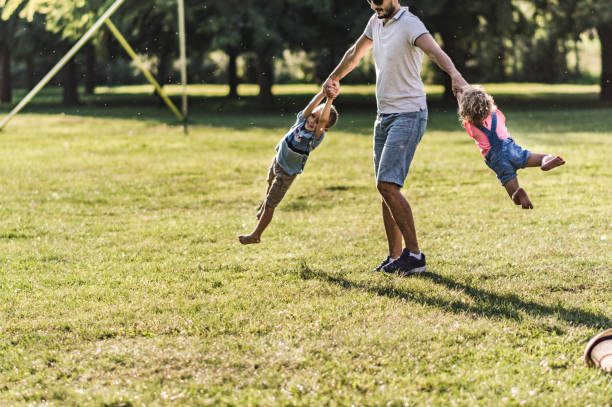 istock Father is spinning kids around 1213843839