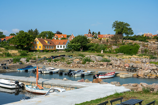 Svaneke, Bornholm / Denmark - July 29 2019: View over the Village Svanake in Bornholm with a small harbor in front