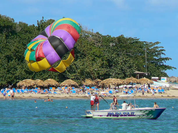 Holiday makers taking part in parasailing in Puerto Plata, Dominican Republic Holiday makers taking part in parasailing in Puerto Plata, Dominican Republic labadee stock pictures, royalty-free photos & images