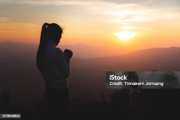 Silhouette Of Young Human Hands Praying To God At Sunrise Christian Religion Concept Background Stock Photo - Download Image Now