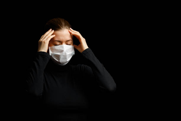 istock The woman with the mask has a headache. 1213849167