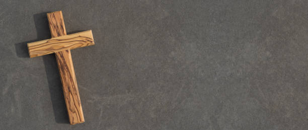 istock wooden Cross on dark slate background 1213849715