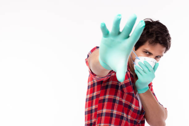 Man stop illness, Please stop spreading viruses, flu, covid19, coronavirus to people. Young guy wear face mask, medical glove He get suffer from air pollution or infection of viruses, flu, coronavirus