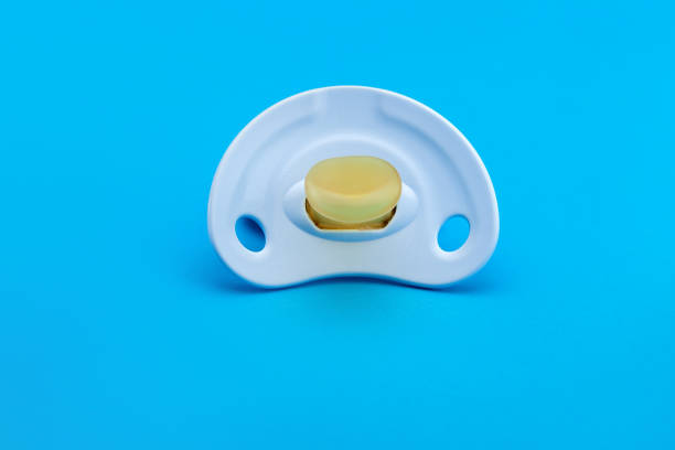 istock a blue pacifier made of soft silicone  isolated on blue background front view with copy space. 1213852923