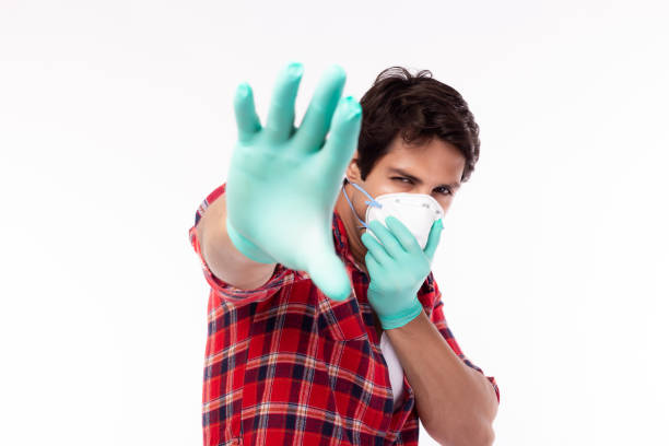 istock Man beg someone, Please stop spreading viruses, flu, covid19, coronavirus to people. Young guy wear face mask, medical glove He get suffer from air pollution or infection of viruses, flu, corona virus 1213853018