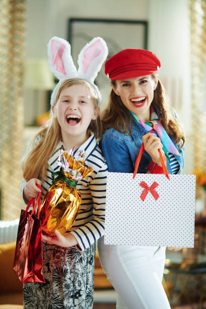 happy trendy mom and child holding egg and shopping bags - pre teen boy flash imagens e fotografias de stock