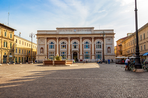 Pesaro, Italy - May 30, 2018: Piazza del Popolo with fountain and the building of the post office