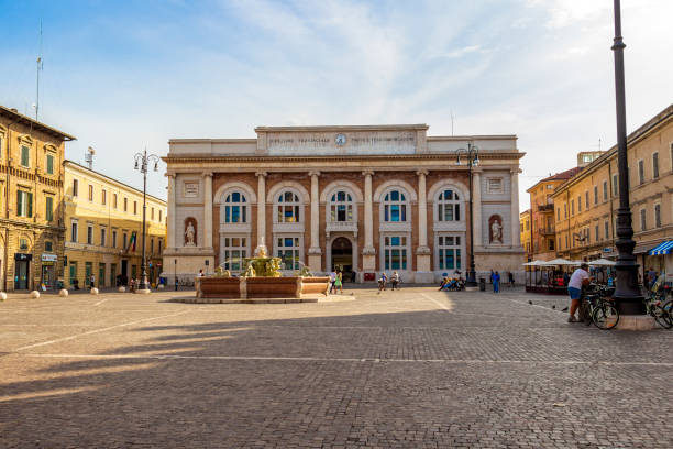 Pesaro, Italy beautiful old architecture Pesaro, Italy - May 30, 2018: Piazza del Popolo with fountain and the building of the post office marche italy photos stock pictures, royalty-free photos & images