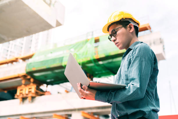 smart asian engineer manager mit sicherheitsgleich erkundlichen prüfstellenbau mit stahl- und betonstrukturhintergrund - manual worker portrait helmet technology stock-fotos und bilder