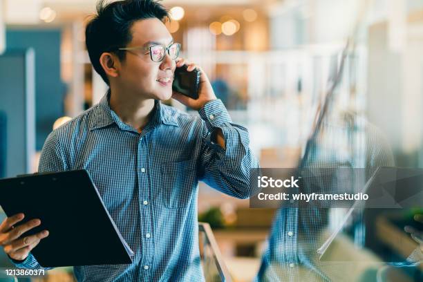 Smart Confidence Asian Startup Entrepreneur Business Owner Businessman Smile Hand Use Smartphone Woking In Office Background Stock Photo - Download Image Now