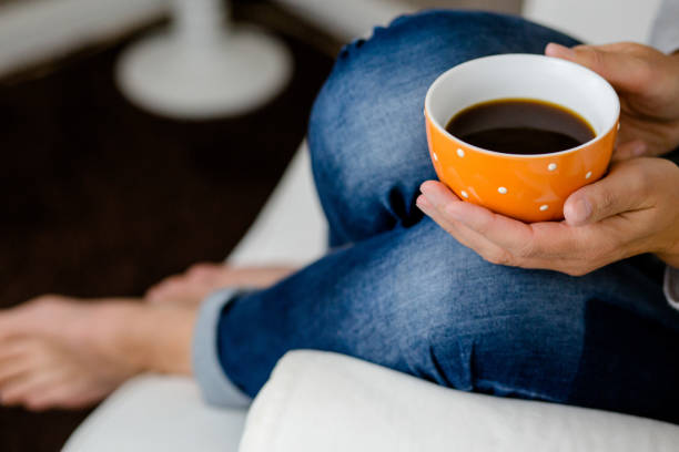 istock A woman holds a coffee cup 1213860635