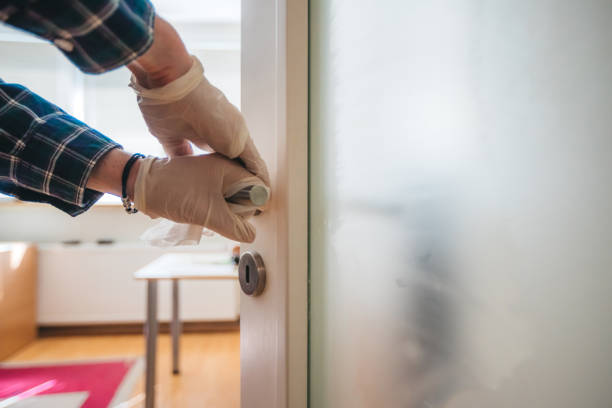 istock Cleaning a door handle with disinfection wipes. 1213861489