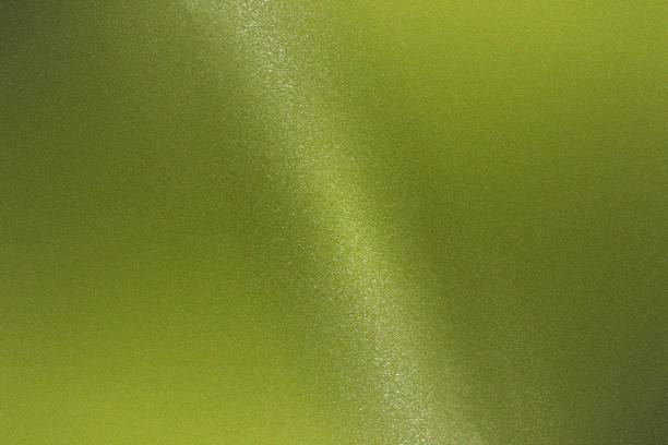 istock Glowing light green metallic wall with copy space, wallpaper texture background 1213861595