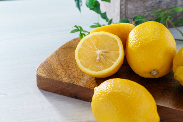 istock Sliced lemon fruit isolated on wooden background 1213862043
