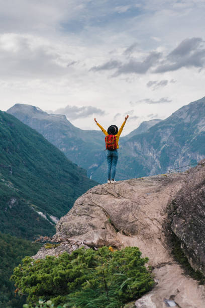 istock Woman with hands up standing  in mountains in Norway 1213862654