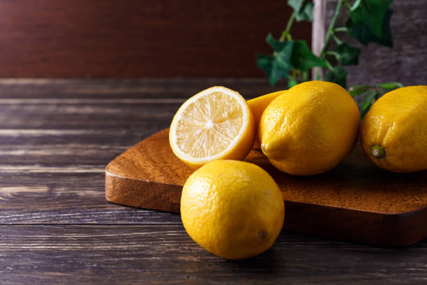 istock Sliced lemon fruit isolated on wooden background 1213862689