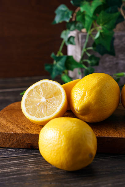 istock Sliced lemon fruit isolated on wooden background 1213862698