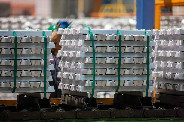 Freshly molded aluminum ingots stacked on pallets, ready for distribution. Freshly molded aluminum ingots from recycled aluminum waste, stacked on pallets, ready for distribution. aluminum plant stock pictures, royalty-free photos & images