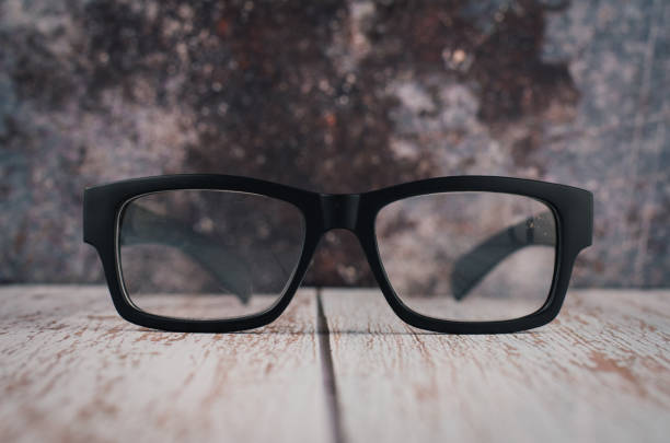black frame eye glasses on wooden desk
